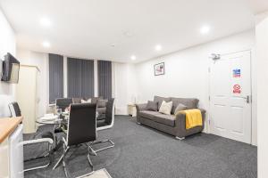 a living room with a couch and a table at Velvet Coaster Apartments in Blackpool