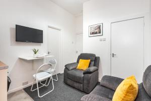 a living room with a couch and a chair at Velvet Coaster Apartments in Blackpool