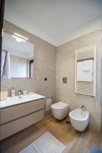 a bathroom with a sink and a toilet and a mirror at IULIA FELIX B&B in Pompei