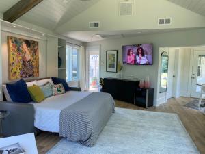 a bedroom with a bed and a tv on the wall at Riverview Suite at La Soledad in Harpers Ferry