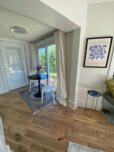 a living room with a table and a window at Riverview Suite at La Soledad in Harpers Ferry +31 photos
