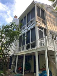 a house with a balcony on the side of it at Trouvaille House Sweet Suite in Harpers Ferry