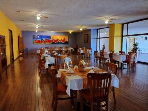 a dining room with tables and chairs in a restaurant at The Halfway Inn in Guerrero Negro