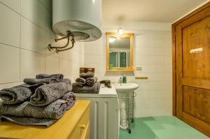 a bathroom with a sink and a mirror and towels at Alpine Essence, typical mountain style apartment CIR AYAS0036 in Champoluc +22 photos