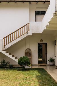 a staircase in a house with a yard at Watu House in Dickwella