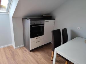 a kitchen with a stove and a table with chairs at Ferienwohnung Beelen in Beelen