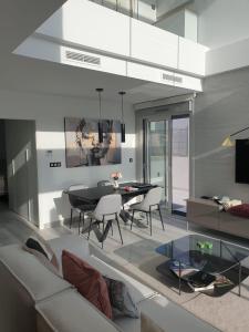a living room with a black table and chairs at Casa Janna in Cabo Roig