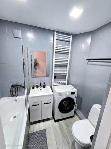 a bathroom with a washing machine and a washer at Apartments in Bălţi