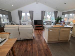 a living room with a couch and a table at Hillside View in Morpeth