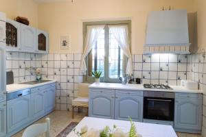 a kitchen with blue cabinets and a window at il nuvoloso 2 in Città della Pieve +30 photos