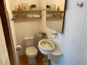 a small bathroom with a toilet and a sink at Casa Creta Doradal in Doradal +18 photos