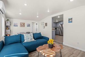 a living room with a blue couch and a table at Charming Escape with Stylish Decor & Outdoor Space in Glendora +39 photos