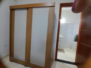 a sliding glass door in a bathroom with a shower at Apartamento aconchegante em ilheus in Ilhéus +8 photos