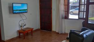 a living room with a television on a wall at La Elvira in San Antonio de Areco