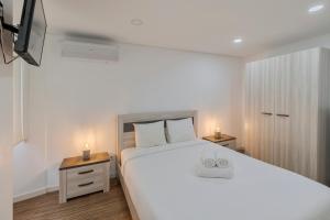 Postel nebo postele na pokoji v ubytování Maison du Village - Sesimbra