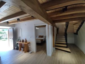a room with a staircase and a living room at Casa Rural El Pinche in Quincoces de Yuso