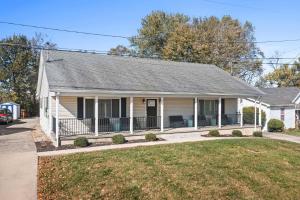 a white house with a porch and a yard at Family Home and Comfort 2 Min to Ark 4 bdrm in Williamstown