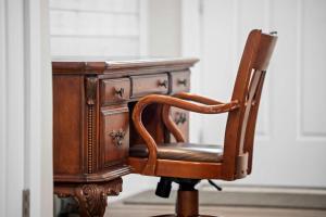an old wooden desk with a chair next to it at Family Home and Comfort 2 Min to Ark 4 bdrm in Williamstown +21 photos