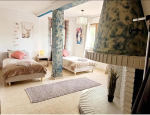 a bedroom with two beds and a mirror at Montevistas Retreat- Cycling, Hiking, Relaxation, Valencia 25 minutes in Valencia