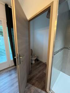 an open door to a bathroom with a toilet at Appart cosy proche plage in Calais +42 photos
