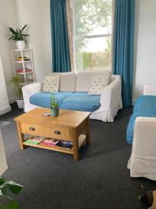 a living room with a couch and a coffee table at The Firs, Frampton Lane, Boston, Lincolnshire, PE20 1SH in Boston