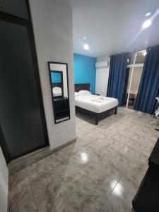 a bedroom with a bed and a mirror in it at Hotel Turquesa in Playa del Carmen
