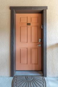 eine orangefarbene Tür an der Seite eines Gebäudes in der Unterkunft Tiki 250 in South Padre Island