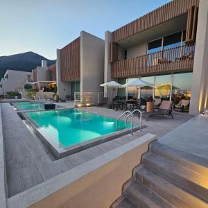 a swimming pool in front of a building at Villa Champagne Green Coast Palase in Palasë
