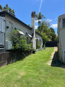 una casa con un patio de césped al lado de una casa en CozyHomes Woolloongabba Comforts, en Brisbane
