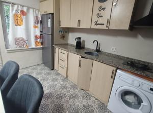 a kitchen with a washing machine and a sink at Happy Accomation Houses 192mt to Harbour no6 in Marmaris