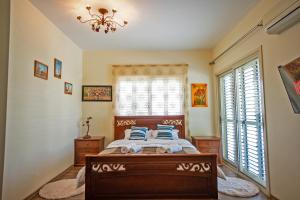 a bedroom with a bed and two windows at Beachfront Villa Larnaka Dhekelia with Pool in Pyla