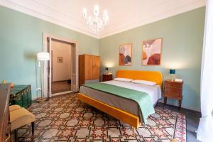 a bedroom with a bed and a chandelier at La Dimora degli Attori in Catania