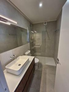 a bathroom with a sink and a shower and a toilet at Casa Francisca praia de Mindelo in Mindelo +32 photos