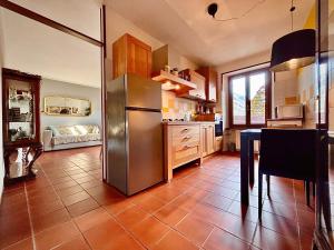 a kitchen with a stainless steel refrigerator and a table at Oh!megna in Omegna