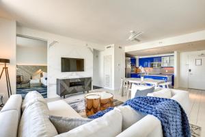 a living room with a white couch and a fireplace at Walk to A1A and Beach Park Fort Lauderdale Oasis! in Fort Lauderdale