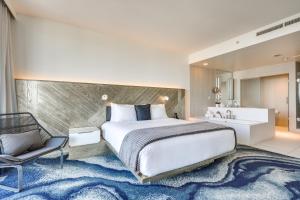 a bedroom with a large bed and a bathroom at Resort Perks Luxe Florida Condo Near Restaurants! in Fort Lauderdale +18 photos