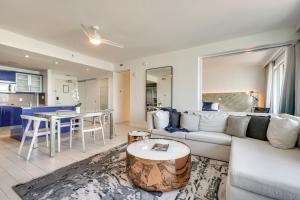 a living room with a couch and a table at Steps to Fort Lauderdale Beach Oceanfront Condo in Fort Lauderdale