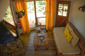 a living room with a couch and a table at Lelikelen Cabañas del Bosque in Villa La Angostura