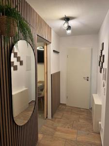 a hallway with a mirror and a room with a door at Traumhafte Nächte, unvergesslich in Chemnitz