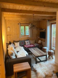 a living room with a couch and a table at Chalet Villars-Gryon 8pax Cosy in Gryon