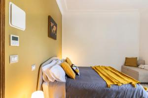 a bedroom with a bed with yellow walls at Al CASTELLO AVEZZANO in Avezzano