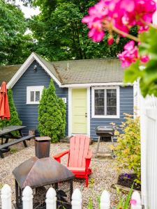 a blue house with a picnic table and a grill at Cottage 5-6 - 2 Bedroom / 1 Bath End Unit in Wolfeboro