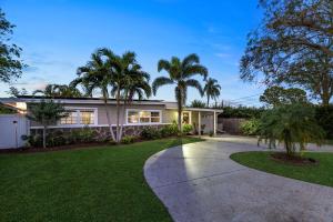 a house with palm trees and a driveway at Seminole Shores Private Pool Outdoor Games Wifi in Redington Shores