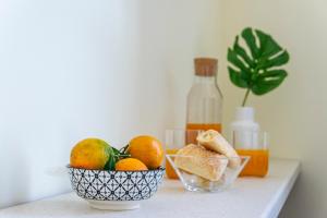 a bowl of fruit on a table with a bottle of wine at Al CASTELLO AVEZZANO in Avezzano