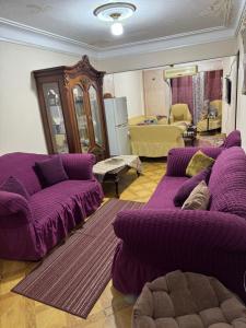 a living room with purple couches and a couch at Apartment in Portsaid Sea view in Port Said