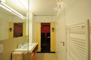 a bathroom with a sink and a mirror at Appartements Lenzikopf in Brand +50 photos