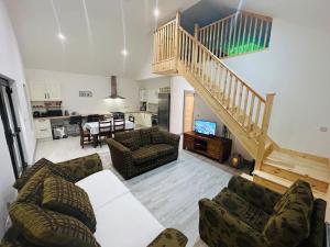 a living room with a couch and a staircase at Hillview Lodge in Barrysbrook