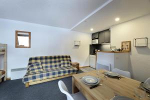 ein Wohnzimmer mit Sofa und Tisch in der Unterkunft Résidence Carroley B - Chaleureux studio · Proche des pistes · Vue pistes MAE-3785 in Mâcot La Plagne