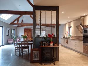 eine Küche mit Tisch und ein Esszimmer in der Unterkunft L 'Aupinouse Chambre double Pivoine avec salle d'eau privative in La Suze-sur-Sarthe