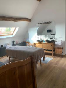 a bedroom with a bed and a dresser and a mirror at Le relais de poste Valero in Serazereux